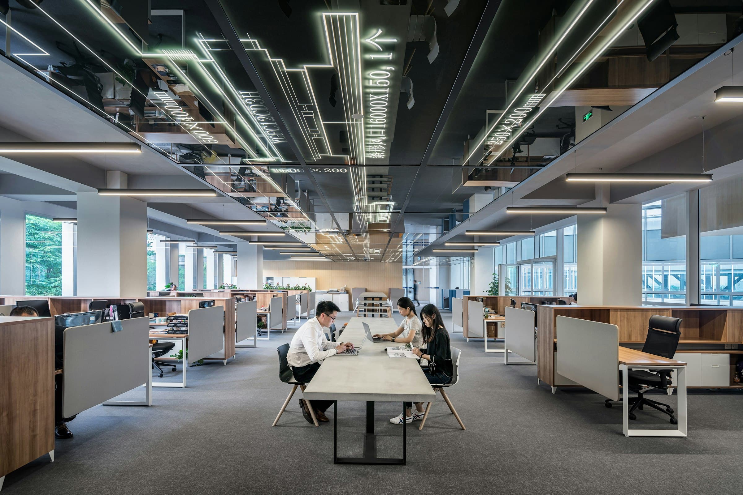 A modern operations floor with teams working at long shared desks