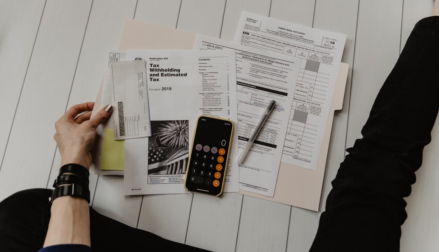 Tax documents, a calculator and worksheets spread on a desk